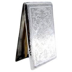Silver cigarette case with Arabic-style engraved floral motifs and hinged lid