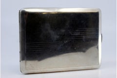 Silver cigarette case with asymmetrical engraving, gold interior and hinged lid