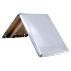 Silver cigarette case with asymmetrical engraving, gold interior and hinged lid
