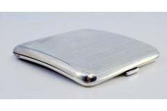 Silver cigarette case with bands on top, cigarette holder inside and hinged lid