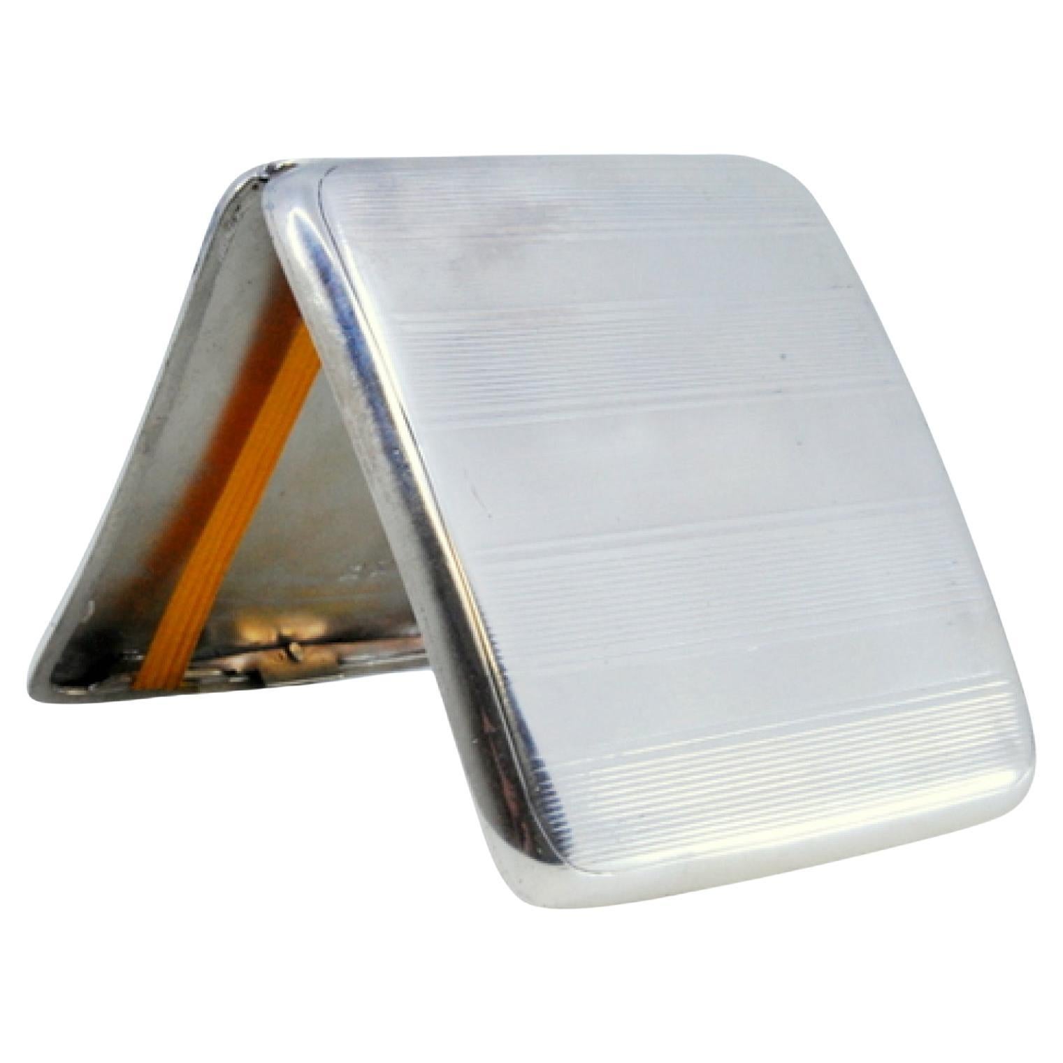 Silver cigarette case with bands on top, cigarette holder inside and hinged lid