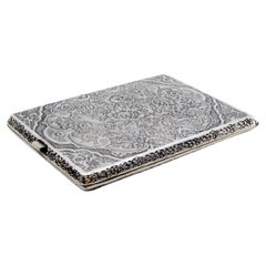 Silver cigarette case with bird and flower reliefs