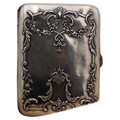 Silver cigarette case with bows, embossed garlands and hinged lid