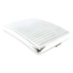 Silver cigarette case with curved guilloche bands at the top