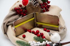 Silver cigarette case with engraved bands along the length and monogram card