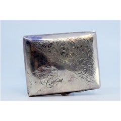 Silver cigarette case with engraved curved scrolls and hinged lid