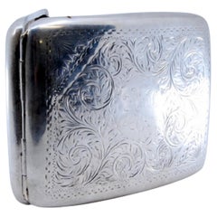 Silver cigarette case with engraved curved wreaths and dividers inside