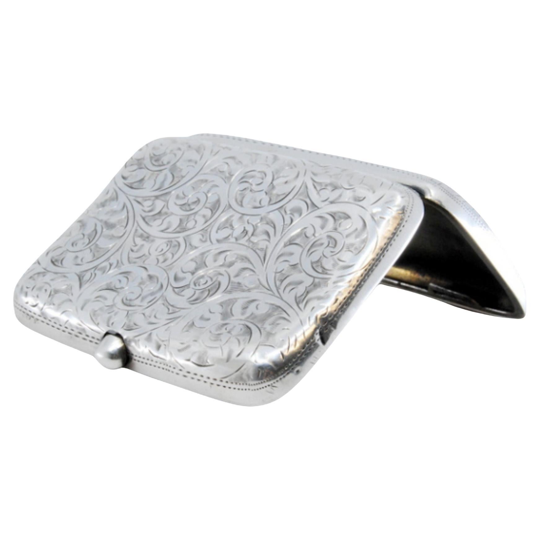 Silver cigarette case with engraved floral motifs and hinged lid