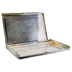 Silver cigarette case with engravings and hinged lid with spring for opening