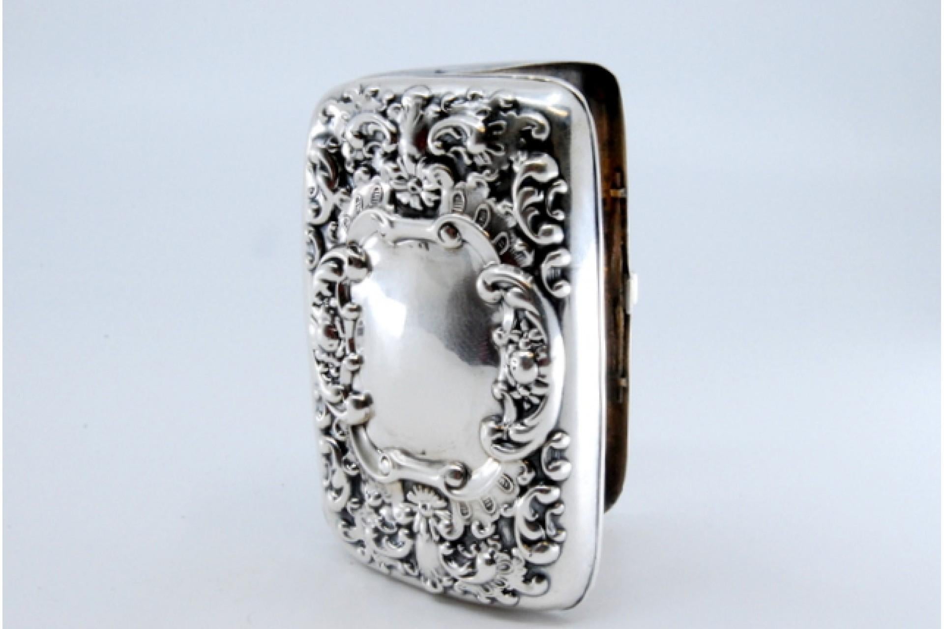 Description: Silver cigarette case with engraving, cigarette holders inside and hinged lid. Metal: Silver. Origin: English. Mark: Unreadable. Weight: 42.30 grams. Dimensions: 7.5x1.5cm. Content: 925/1000. Assay Mark: Unreadable. Additional