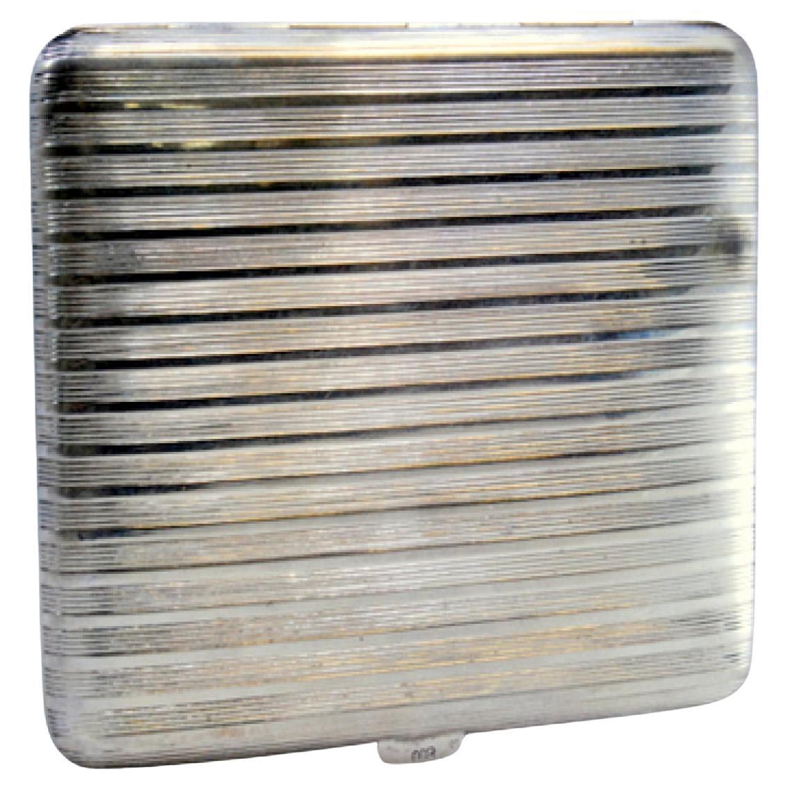 Silver cigarette case with fluted bands, gold interior and hinged lid