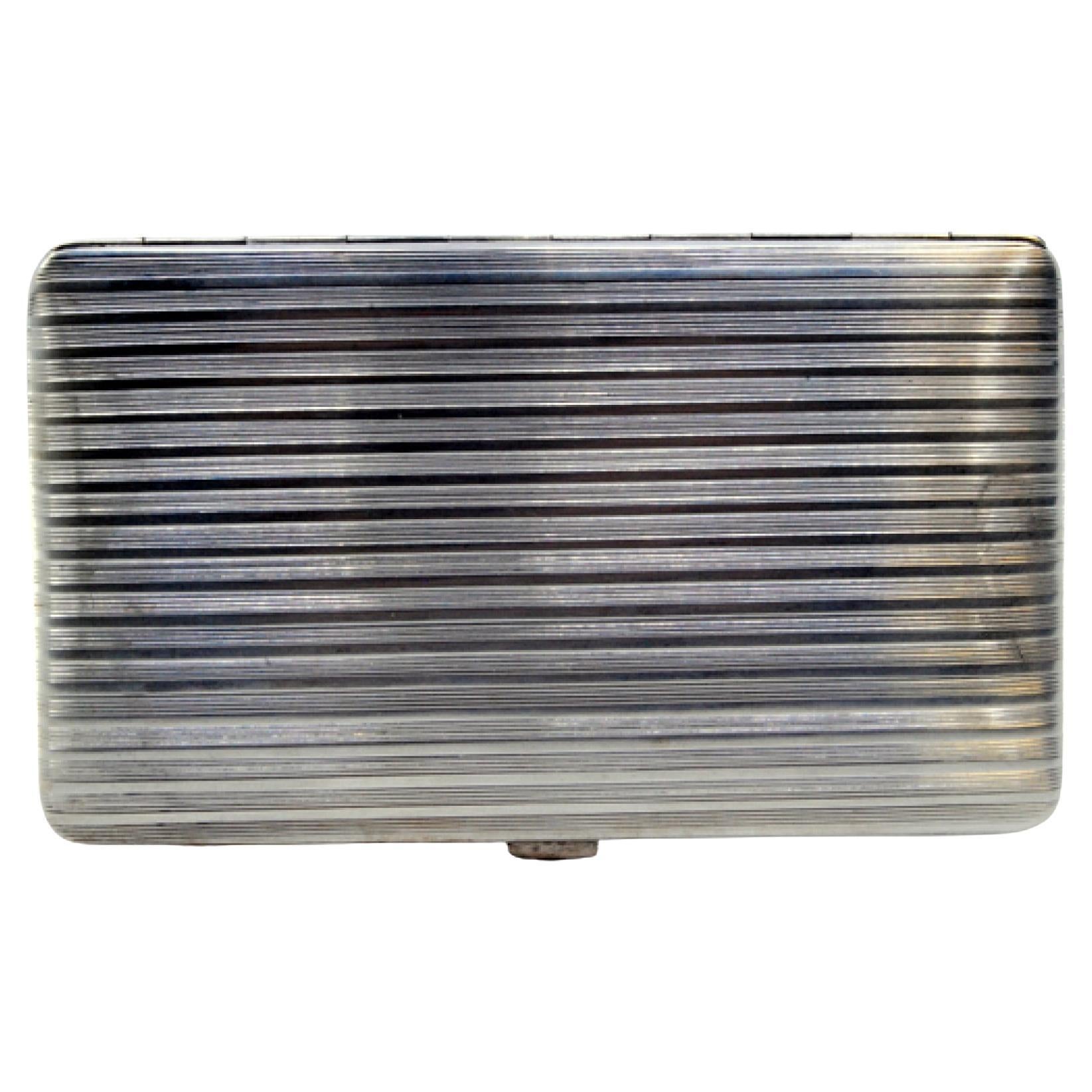 Silver cigarette case with fluted bands on both sides and hinged lid