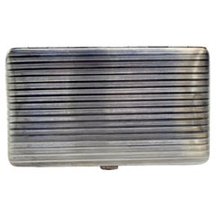 Silver cigarette case with fluted bands on both sides and hinged lid