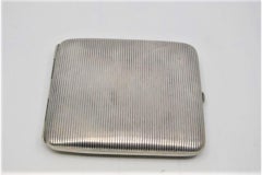 Silver cigarette case with fluted top and gold interior and hinged lid