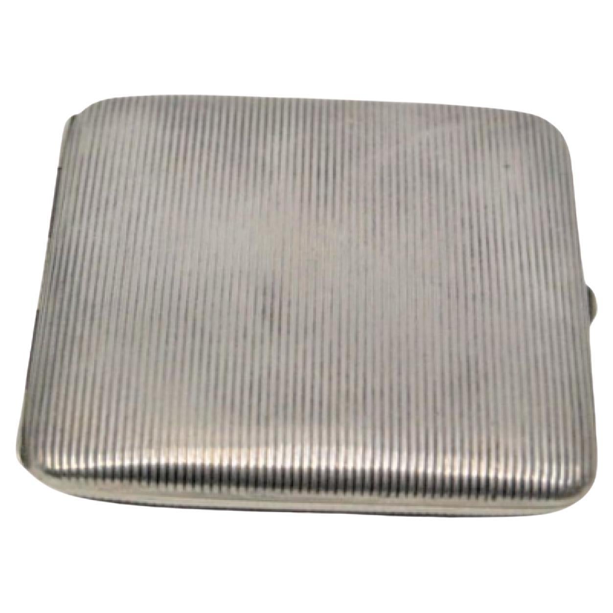 Silver cigarette case with fluted top and gold interior and hinged lid