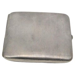 Silver cigarette case with fluted top and gold interior and hinged lid