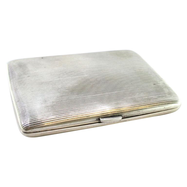Silver cigarette case with fluted top, gold-toned interior and hinged lid