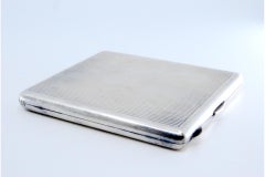 Silver cigarette case with fluting along the length and interior with cigarette