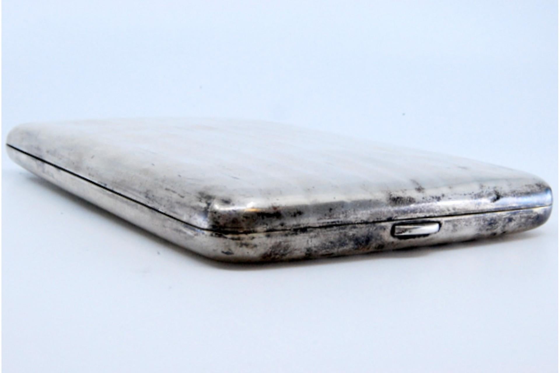 Description: Silver cigarette case with guilloche bands and gold interior. Metal: Silver. Origin: German. Brand: Unknown. Weight: 140.71 grams. Dimensions: 12.7x1.1cm. Content: 800/1000. Assay Mark: Yes. Additional information: Good condition.