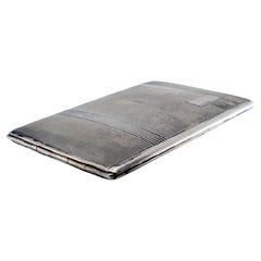 Silver cigarette case with guilloche bands at the top and hinged lid