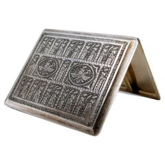 Silver cigarette case with Middle Eastern-style reliefs and a hinged lid