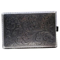 Silver cigarette case with plant engravings, waves on the edge and hinged lid