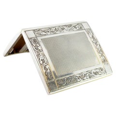 Silver cigarette case with reliefs, brushed silver lid and base trims