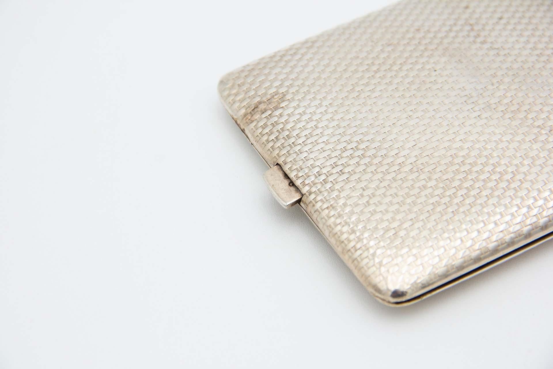 Description: Silver cigarette case with recessed and rectangular reliefs. Metal: Silver. Origin: Portuguese. Brand: javali II Title. Weight: 164.30 grams. Dimensions: 14.7cmx1.2cm. Content: 833/1000. Assay Mark: Yes, between 1887 and 1937.