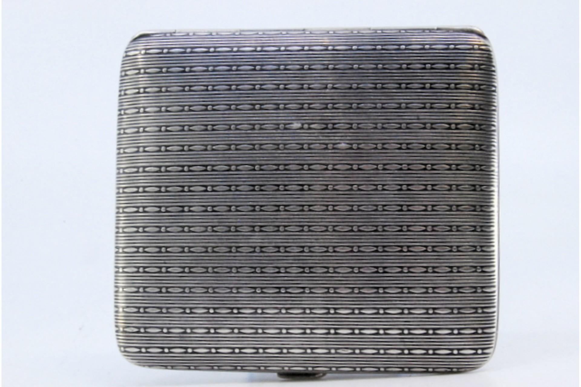 Description: Silver cigarette case with square chiseled reliefs and hinged lid. Metal: Silver. Origin: Belgian. Mark: Unreadable. Weight: 84.37 grams. Dimensions: 8.7x7.8cm. Content: 800/1000. Assay Mark: Yes. Additional information: Signs of use.