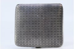 Silver cigarette case with square-shaped chiseled reliefs and a hinged lid