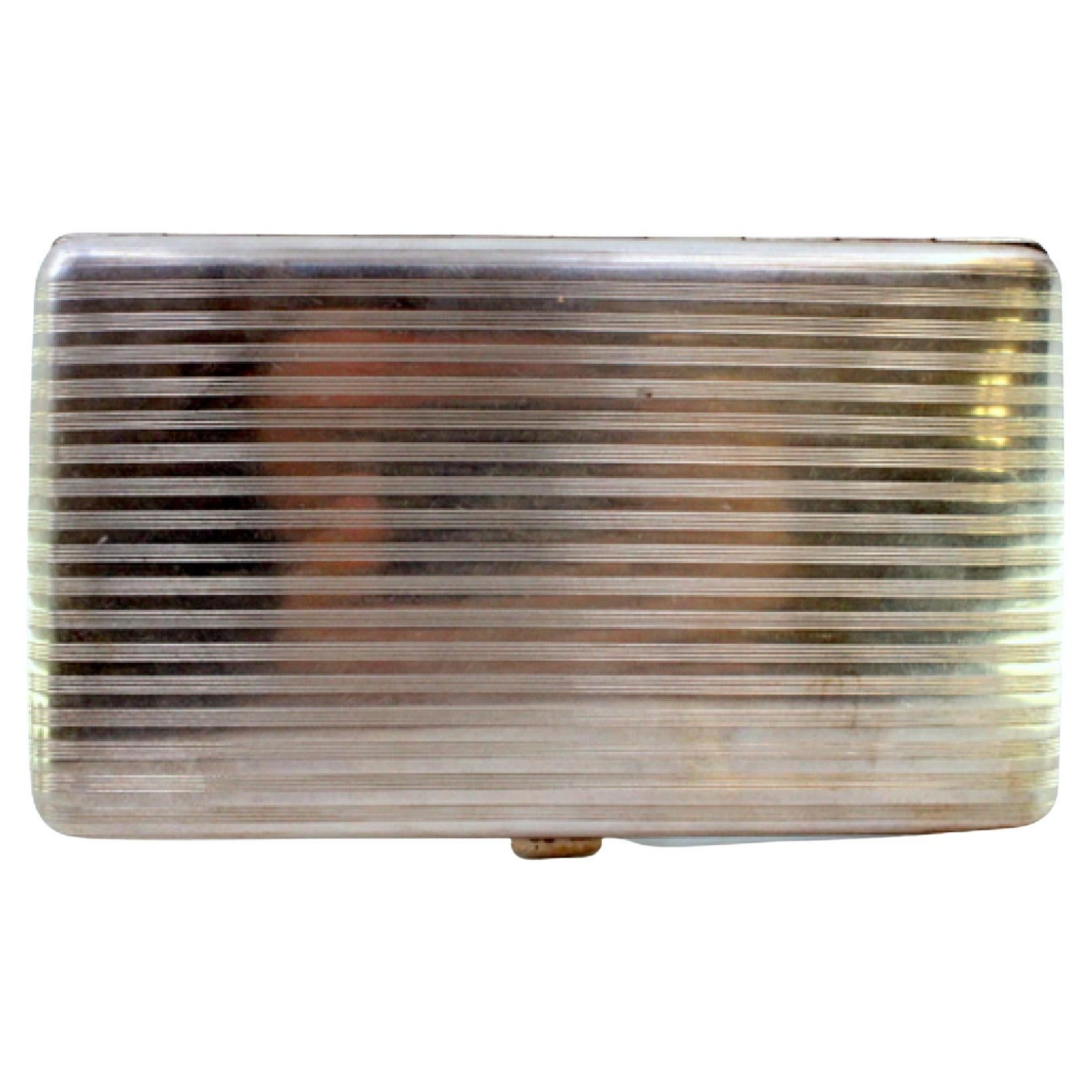 Silver cigarette case with top trim, hinged lid and gold interior