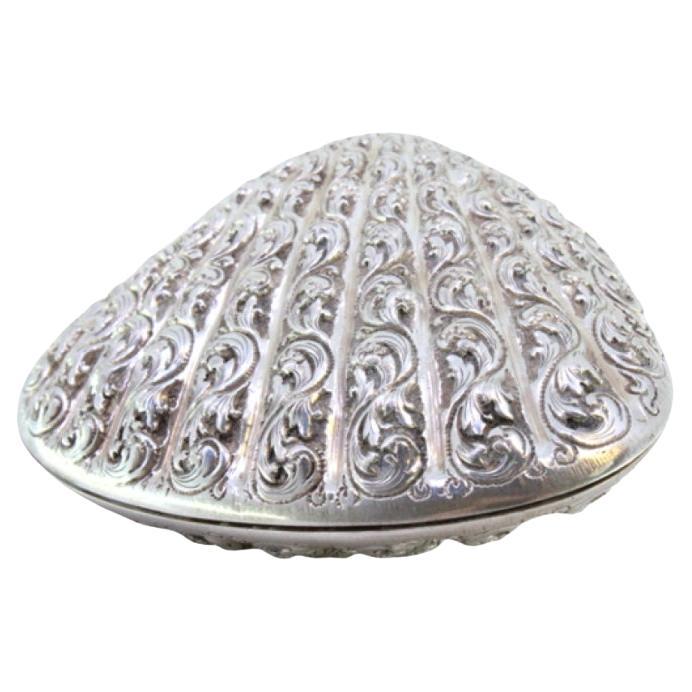 Silver clam-shaped shell with reliefs and double hinged lid