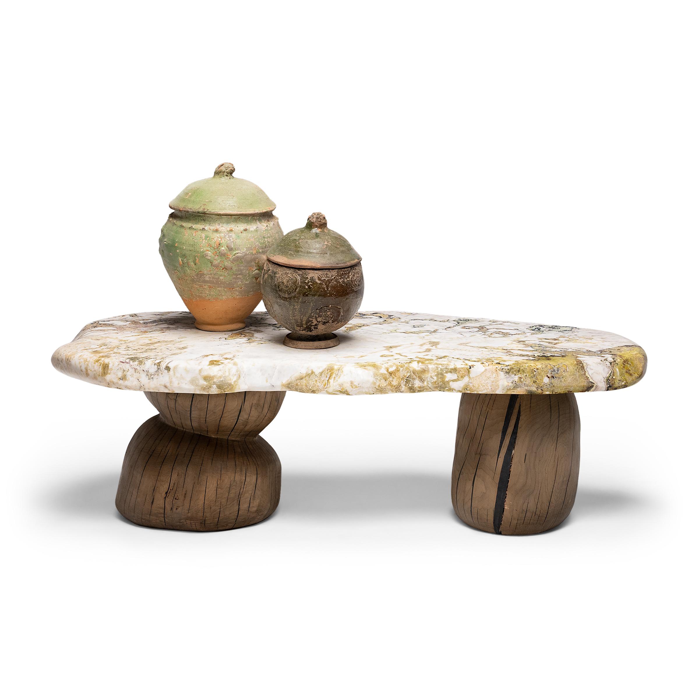 This meditation stone coffee table exemplifies organic modern style with an emphasis on natural materials. The tabletop is solid stone unearthed from Jiangsu province, comprised of white marble with spectacular mineral inclusions. Currents of pink,