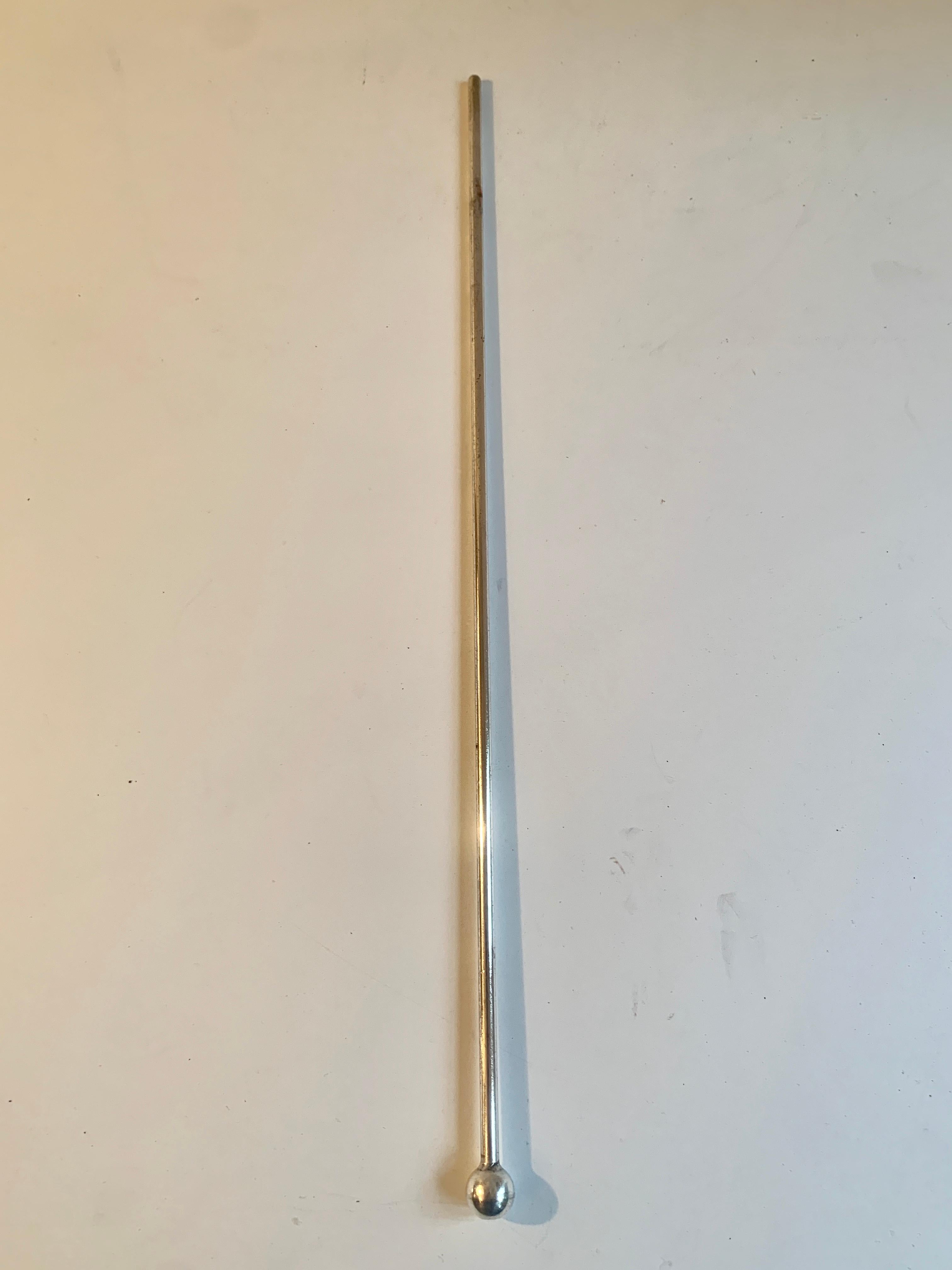 A cocktail stirrer, perfect for any chic martini pitcher - and wonderful for everything from mixed drinks to punches... Not sure if the stirrer is sterling, but definitely plated silver.
 