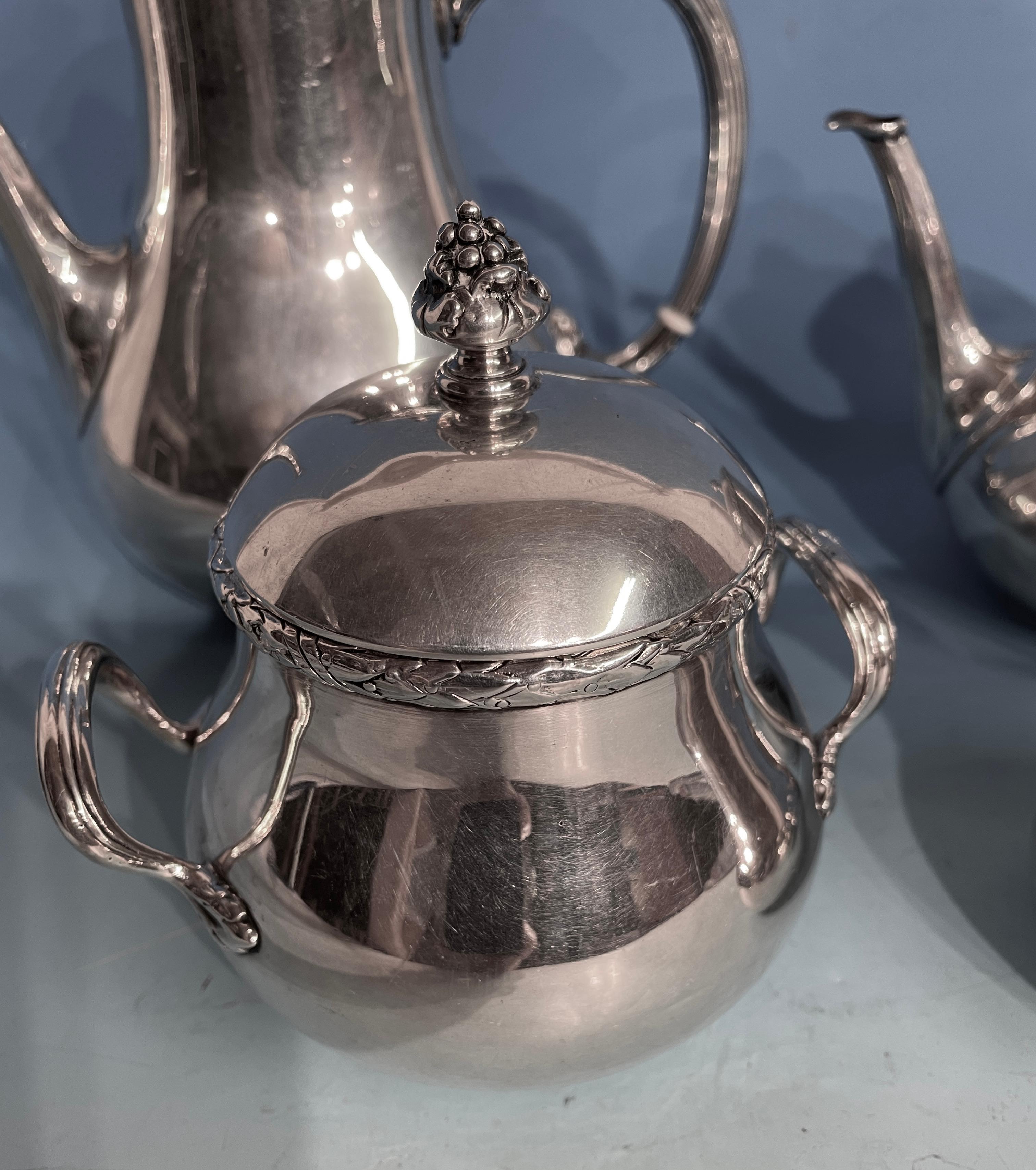 Silver coffee and tea set, Germany 1890-1910.
The pear shaped elegant coffee and tea set has beautiful repoussé details. The rim of the pots and sugar bowl are decorated with a laurel leave garland. At the base of the c-shaped handles are acanthus