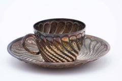 Silver coffee cup and saucer