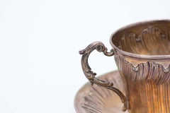 Silver coffee cup and saucer