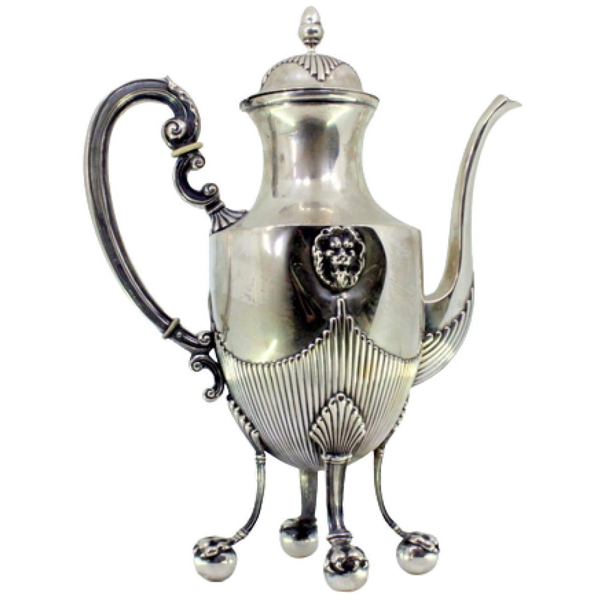 Silver coffee pot with fluted body, lion heads and four claw feet