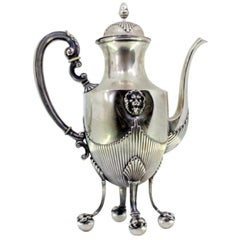 Silver coffee pot with fluted body, lion heads and four claw feet