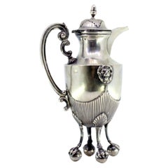 Silver coffee pot with fluting, lion figures and claw-feet on balls