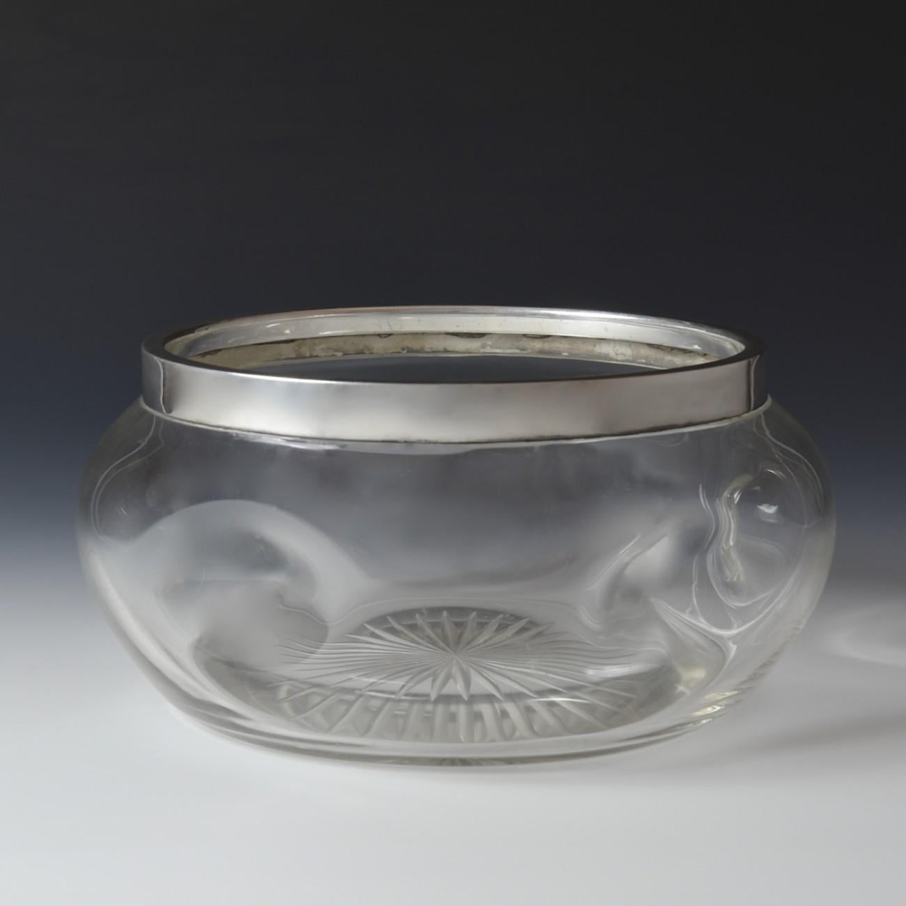 An unusual dimpled glass bowl with star cut to base and Sterling silver collar, hallmarked Sheffield 1903.

Dimensions: 23 cm/9 inches (diameter) x 11 cm/4¼ inches (height)

Bentleys are Members of LAPADA, the London and Provincial Antique Dealers