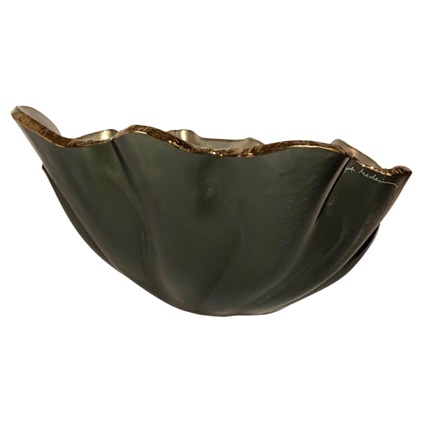 Contemporary Brazilian free form shaped glass bowl.
Metallic silver interior with decorative chiseled rough edges gold in color.
One of several Brazilian designed glass objects.