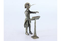 Silver conductor figure with baton and staff