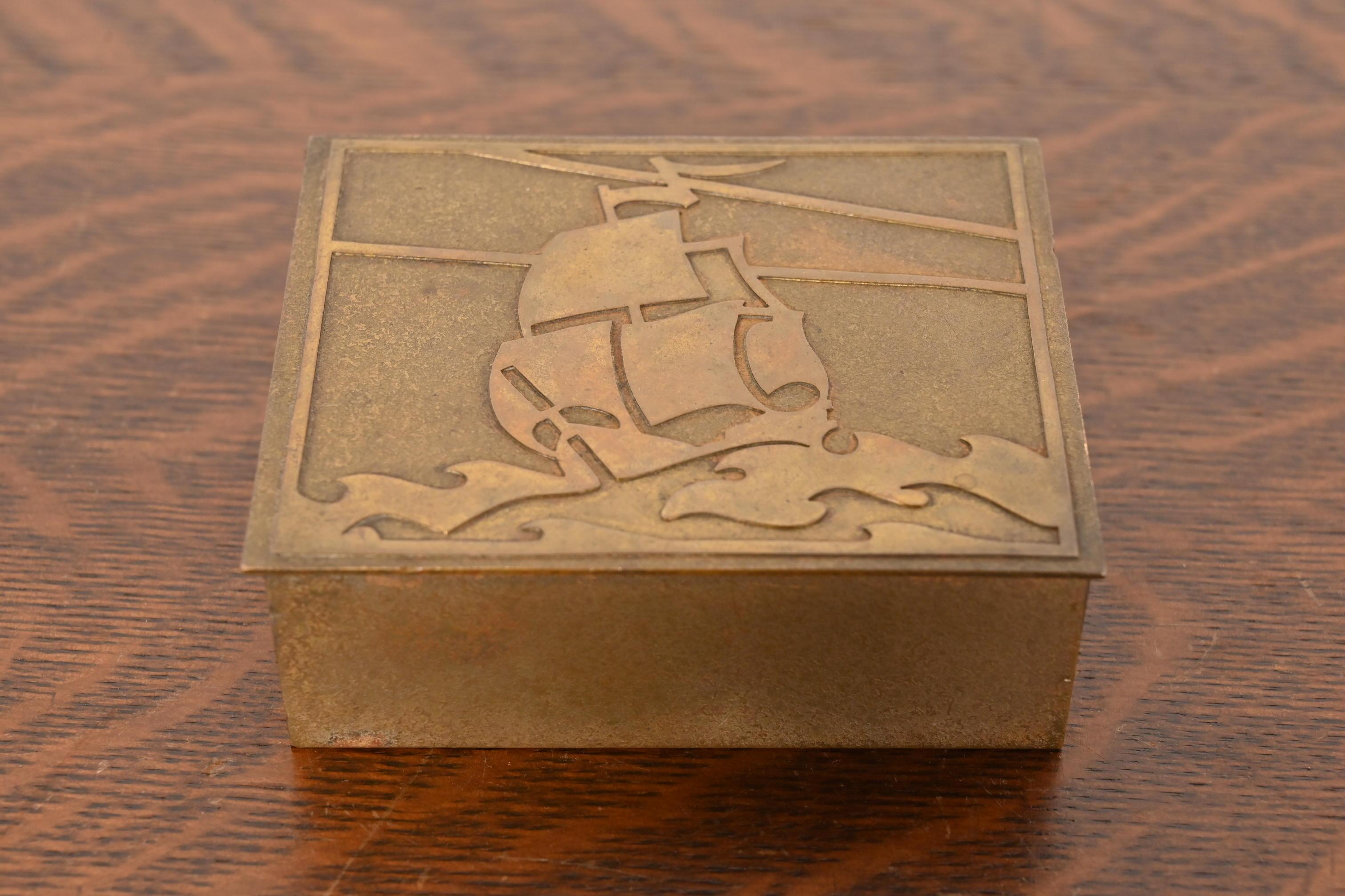 Un bellissimo contenitore da scrivania, portagioie o scatola decorativa in bronzo dorato di epoca Arts & Crafts

Di Silver Crest (il marchio di Smith Metal Arts Co.), una filiale di Heintz Art Metal Shop

Stati Uniti, inizio del XX secolo

Misure: