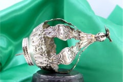 Silver crown with palmettes and cutouts, topped with Holy Spirit dove