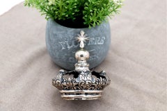 Silver crown with reliefs and applications