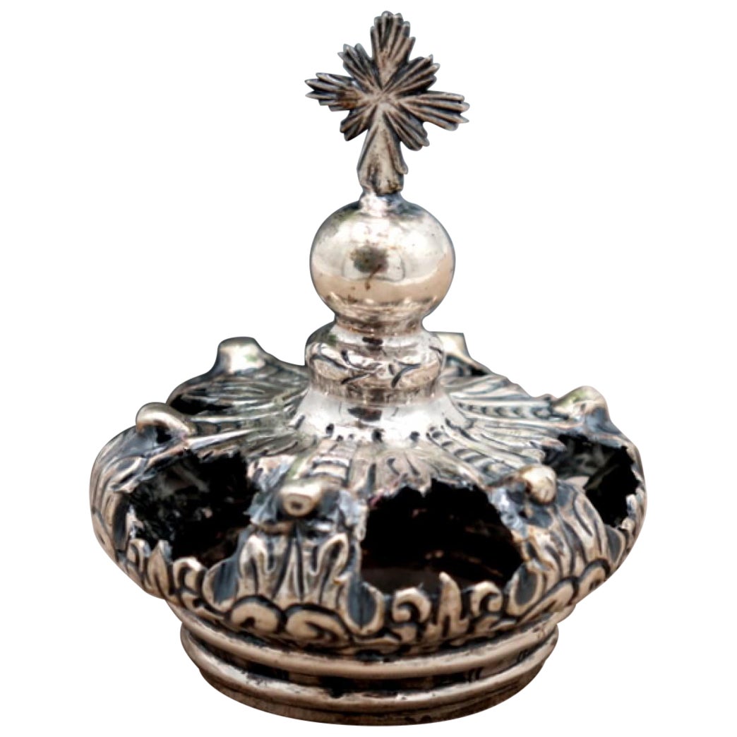 Silver crown with reliefs and applications