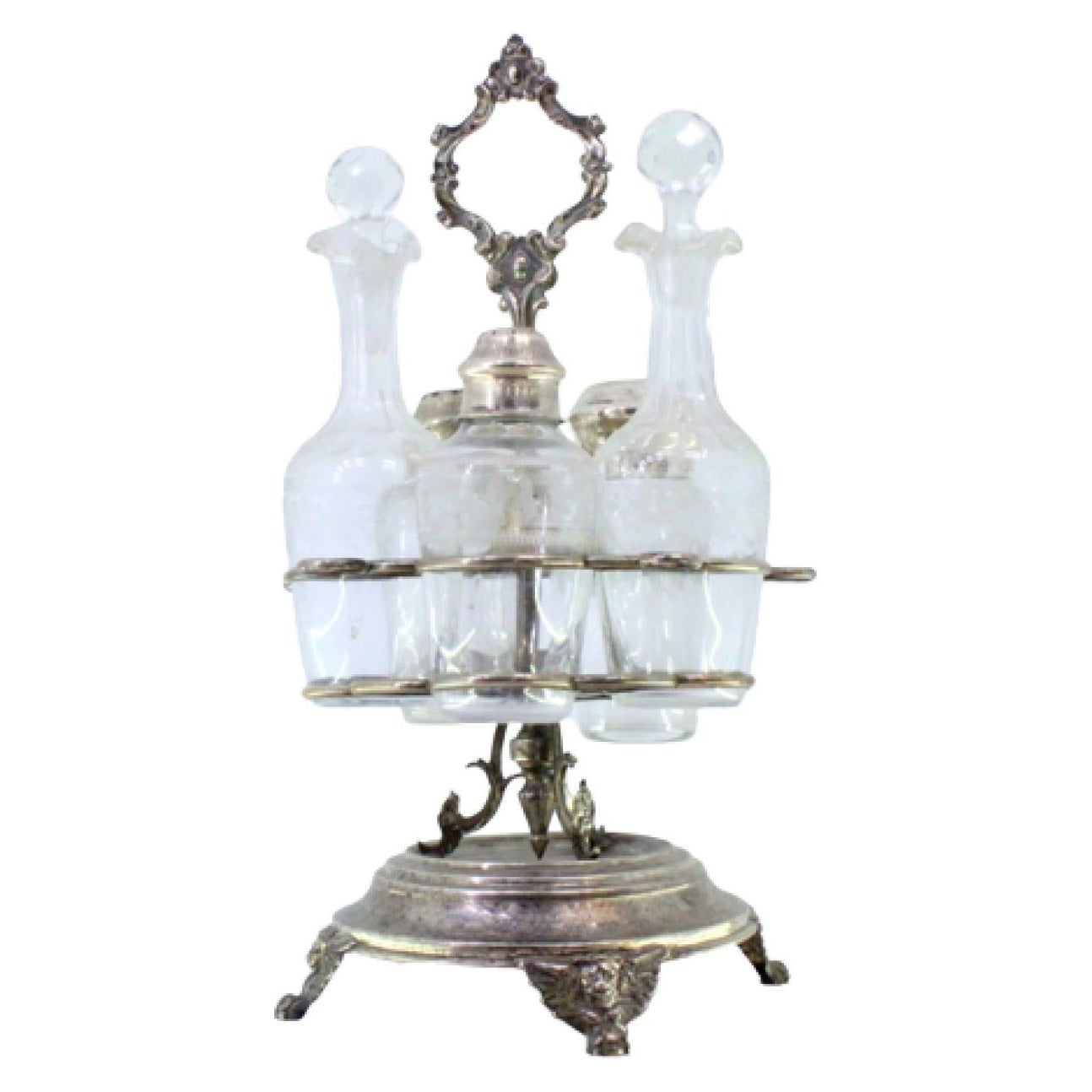 Silver cruet set with polished vessels and three-footed base with masks