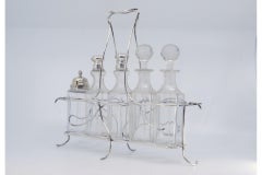 Silver cruet stand with salt, pepper, mustard pot & lid holder