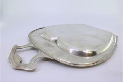 Silver crumb catcher with pearly rim and reliefs on the handle